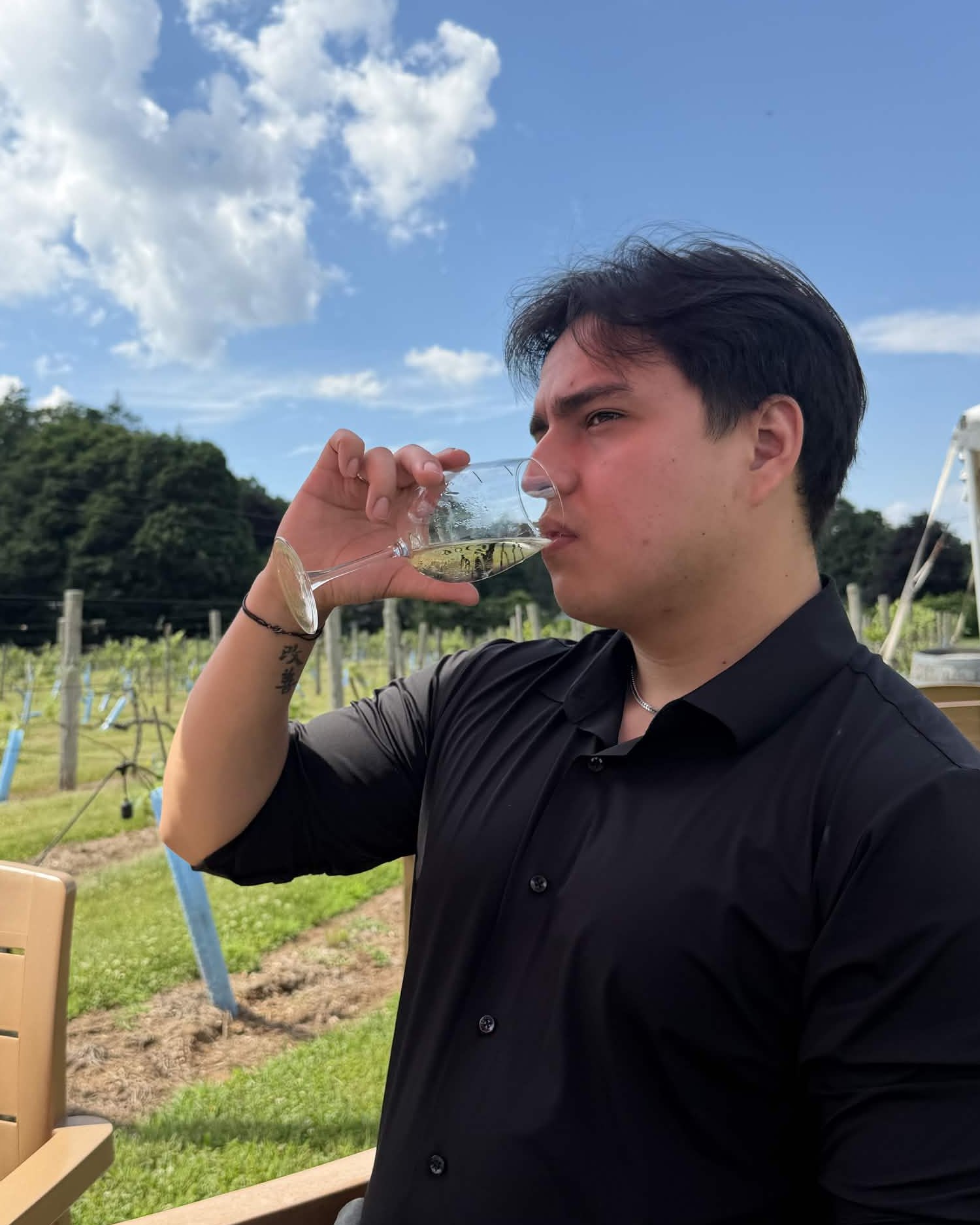 NUVIA founder sipping sparkling wine at a vineyard.
